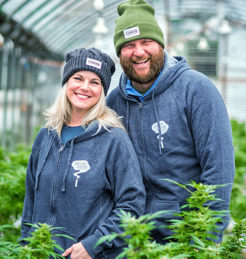 Best Blue Hoodie by Appalachian Standard with Amy and Jesse of Appalachian Standard standing in the CBD Hemp plants in the greenhouse in Asheville, NC.
