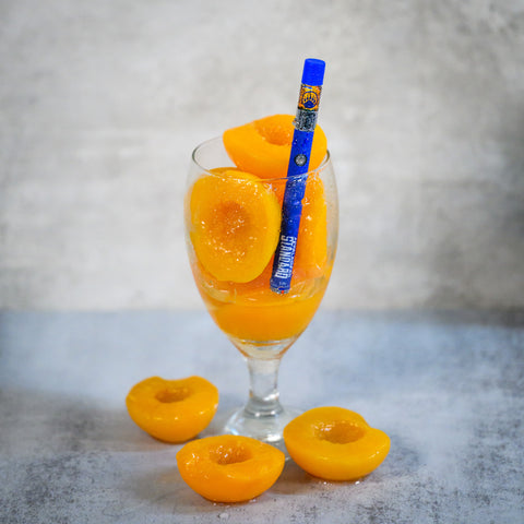 Peach of Mind vape in a glass of juicy peaches from the 2023 summer collection