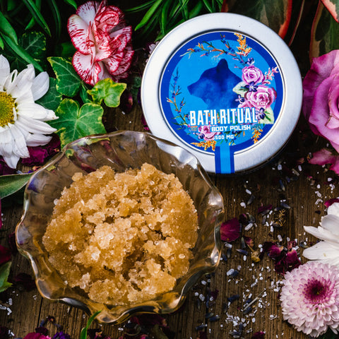 Hemp-infused Luxury body scrub on a table surrounded by flowers at Appalachian Standard.x