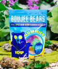 A bag of Appalachian Standard's Boujee Bears CBD Gummies on a bed of moss with plants and flowers in the background
