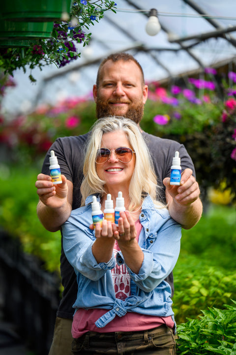 Appalachian Standard owners hold 1 oz bottles of tinctures from the CBD Tincture Trio Bundle