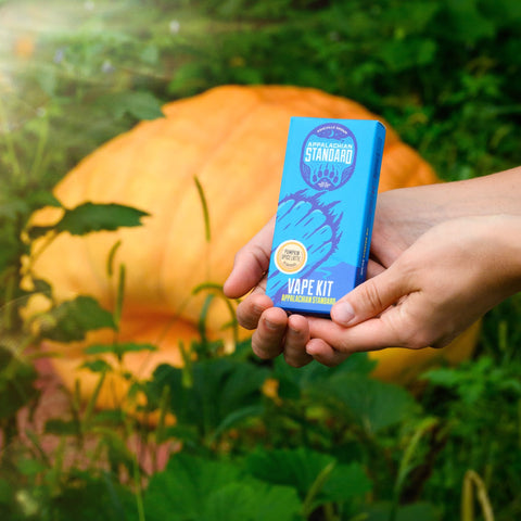 Pumpkin Spiced Latte Vape Kit box in a pumpkin patch next to a large pumpkin by Appalachian Standard.