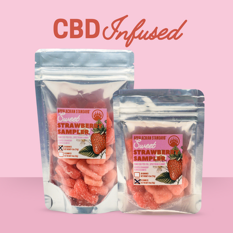 Two packages of "Sweet Strawberry Sampler" gummies against a pink background with "CBD Infused" text above them. The packages are shown in two sizes (30 gummies/4.2oz and 10 gummies/1.4oz), both containing pink strawberry-shaped gummies infused with 25mg CBD per piece.