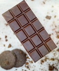 A bar of Appalachian Standard's Mint Chocolate Cookie CBD Chocolate with two mint chocolate cookies on the side
