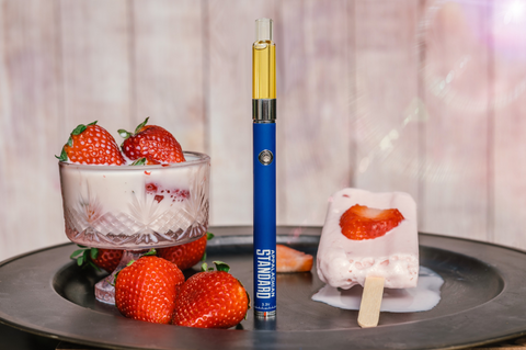 Appalachian Standard's Strawberry Dreamsicle CBD Vape surrounded by strawberries