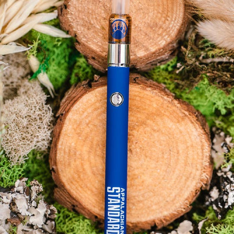 BaOx Hemp Vape Kit with battery on wood cutting by Appalachian Standard.