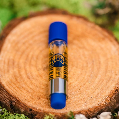 BaOx Hemp Vape Cart on wood cutting by Appalachian Standard.