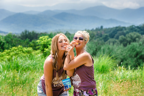 Amy and Lauren eating Appalachian Standard CBD gummies with beautiful Blue Ridge Mountains in the background