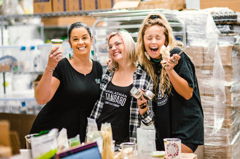 CeeCee, Maegen, and Lauren holding Appalachian Standard CBD products in our lab and smiling for the camera