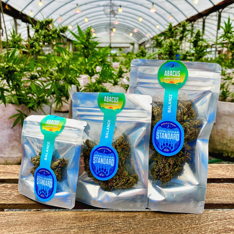 Abacus hemp flower in the Appalachian Standard greenhouse in small, medium, and large packaging