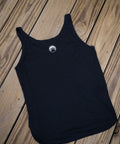 Black tank top with a white logo on a wooden surface