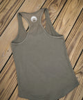 Green tank top with a logo on a wooden surface
