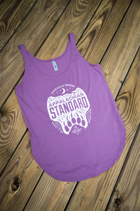 Purple tank top with white graphic design on a wooden surface