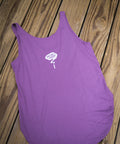 Purple tank top with a white logo on a wooden surface
