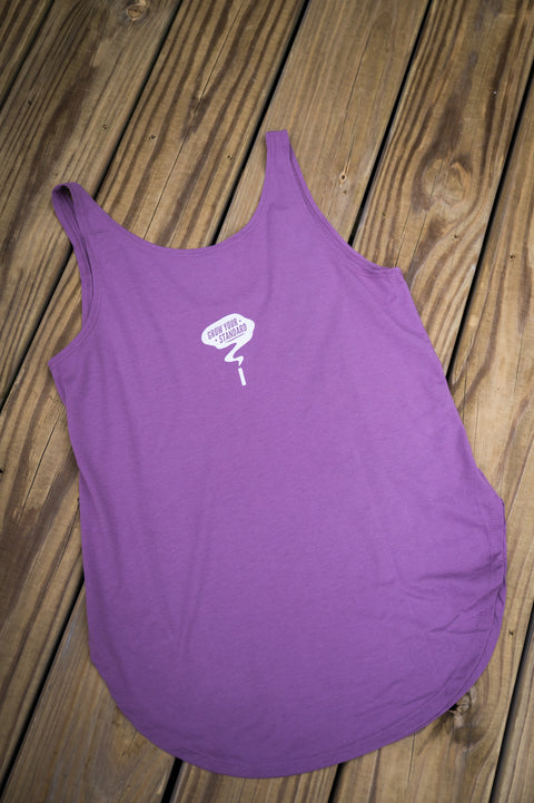 Purple tank top with a white logo on a wooden surface