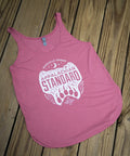 Pink tank top with white graphic design on a wooden surface