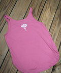 Pink tank top with a logo on a wooden surface