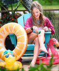 Fiddyshadesofgreen sitting by the pool with pool floaties while applying the hemp lotion by Appalachian Standard. 
