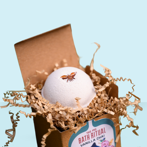 Appalachian Standard Vanilla Chai Bath bomb in a box with decorative paper on a light blue background