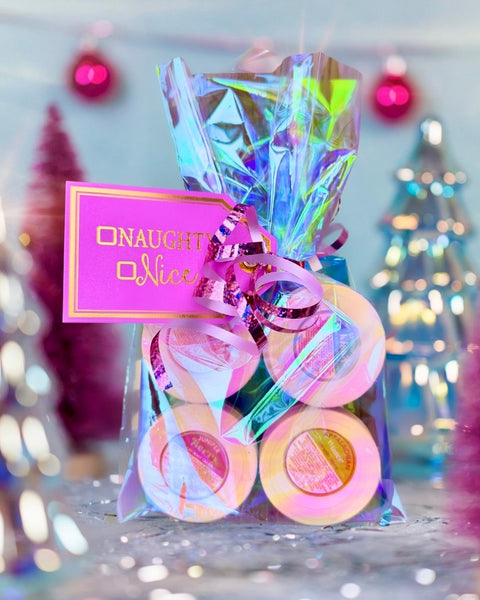Appalachian Standard's decorative gift with colorful candy and 'Naughty or Nice' tag against a blurred festive background