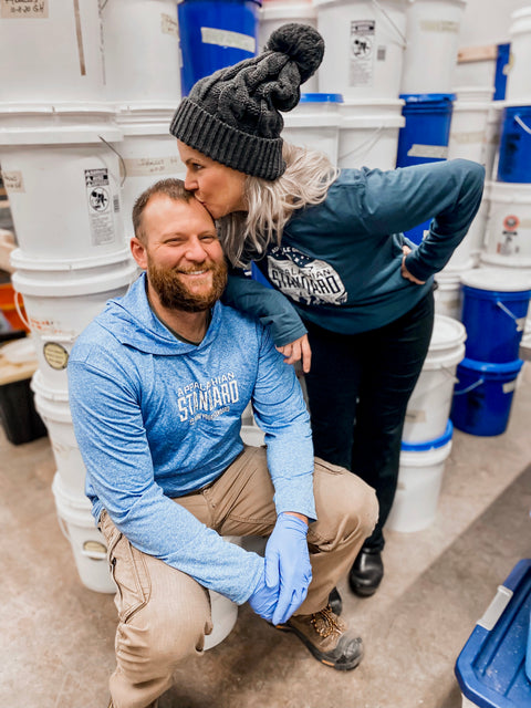 Appalachian Standard's owners in the harvest room among buckets.