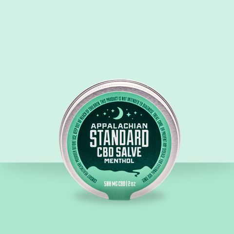 Appalachian Standard's Full Spectrum CBD Hemp Menthol Salve in a chrome tin with a mint green/dark green label on a mint green, ombre background.