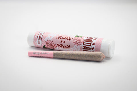Appalachian Standard's Rollin' in the Sheets 1:1 CBD Hemp Pre-Roll in a pink paper in front of the pink rollie tube and in a white box.