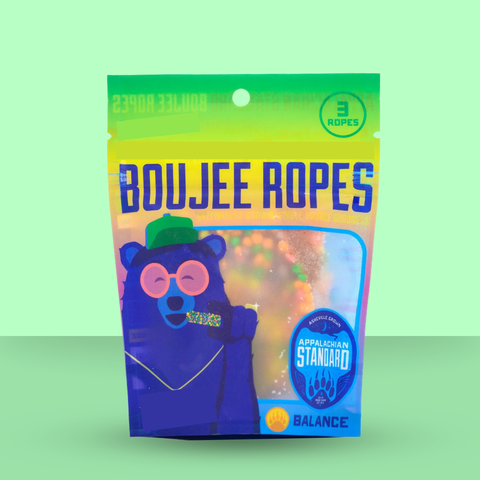 Packaging of Boujee Ropes with a colorful design on a green background
