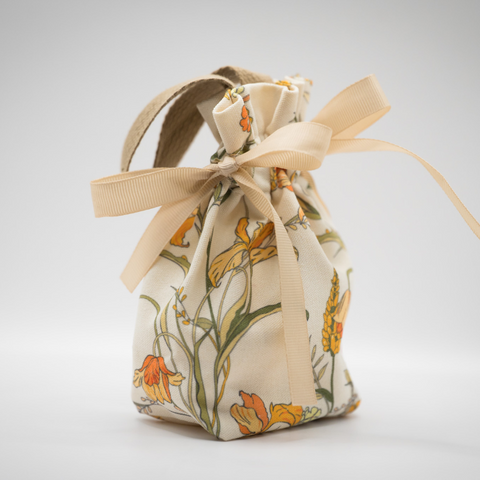 Fabric drawstring bag with floral pattern on a light gray background for Appalachian Standard's High Country Hunny fall CBD body cream launch.