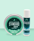 Appalachian Standard's Menthol Salve Tin and Salve Stick with blue/green labels on a green background.