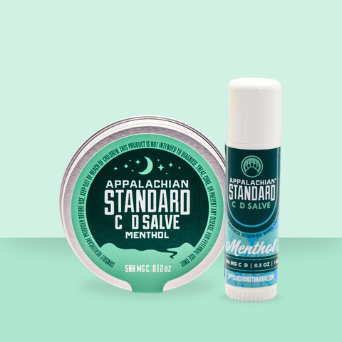Appalachian Standard Menthol Salve container and stick on a light green background