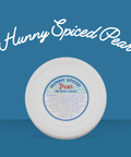 White cylindrical container with a blue label on a blue background, featuring 'Hunny Spiced Pear' text for Appalachian Standard's CBD body cream.