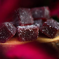 Pieces of Appalachian Standard's Boujee Bears Elderberry CBD Gummies on a small round wooden platter