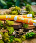 Baox pre-rolls grown by Appalachian Standard lying on wood and moss. 