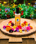 Hemp Southern Sun Body Mist with aloe on a wooden platter surrounded by flowers from Appalachian Standard