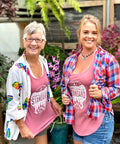 Two women standing in the greenhouse in dusty rose Appalachian Standard tank tops.