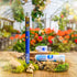 An Appalachian Standard vape with its battery and cart among plants in a greenhouse