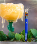 Appalachian Standard's Guava Juice CBD Vape standing upright with a glass of guava juice in the background