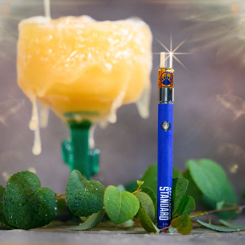 Appalachian Standard's Guava Juice CBD Vape standing upright with a glass of guava juice in the background