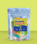 Appalachian Standard Flower Power Energy B12 CBD Gummies in a clear resealable mylar pouch against a lime green background. The label displays 15mg CBD and 15mg CBG per gummy, 150mg total, in green apple, mango, cherry, strawberry, grape, blue raspberry, and orange flavors. Net weight 1.4oz (40g), 10 gummies. Colorful sour gummy candies are visible through the packaging.