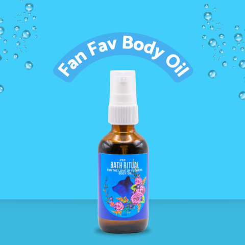 Bottle of 'Fan Fav Body Oil' with a blue label on a blue background