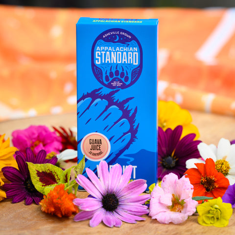 A box of Appalachian Standard's Guava Juice CBD Vape Kit surrounded by flowers