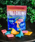 A bag and pieces of Appalachian Standard's Bouj Chews CBD Taffy Candy with plants in the background
