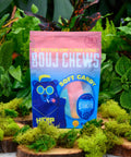 Bouj Chews CBD Candy in packaging in front of leaves and surrounded by moss. 