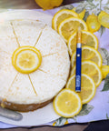 Lemon Cheesecake Vape on top of lemons next to a cheesecake by Appalachian Standard