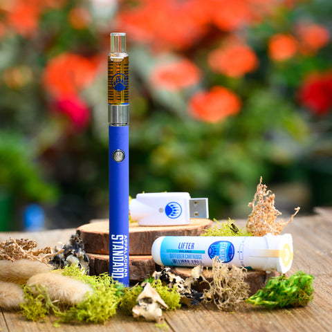 Appalachian Standard's Lifter CBD Vape Kit on wood table surrounded by moss and plants