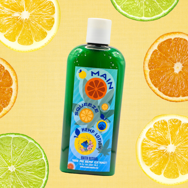 Green bottle of Appalachian Standards Main Squeeze Hemp Lotion, 1000 MG hemp extract, 8 fl oz, with a citrus-themed blue and orange label, styled among lemon, lime, and orange slices