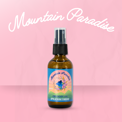 Bottle of Mountain Paradise CBD Body Oil on a pink background