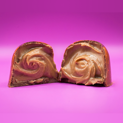 Appalachian Standard's limited edition Ross's Peanut Butter BonBon cut in half to show a swirl of peanut butter filling