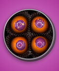 Appalachian Standard's limited edition Ross's Peanut Butter BonBons, eight packaged & airbrushed orange chocolates with purple tops in an open tin.